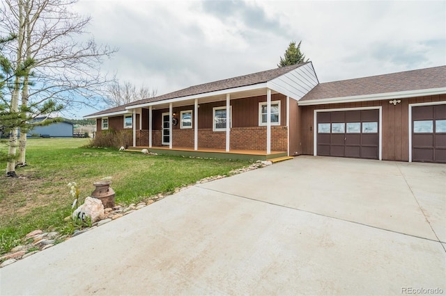 65 Yeoman Ln, Divide, CO 80814 - single story home featuring driveway, an attached garage, a front lawn, brick siding, and a porch