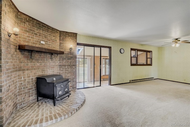 65 Yeoman Ln, Divide, CO 80814 - unfurnished living room with a wood stove, baseboard heating, carpet floors, and ceiling fan