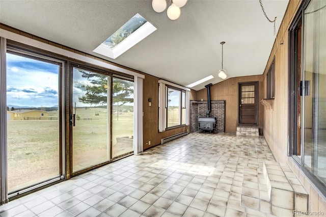 65 Yeoman Ln, Divide, CO 80814 - unfurnished sunroom with lofted ceiling, a wood stove, a baseboard heating unit, and a skylight