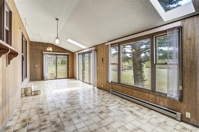 65 Yeoman Ln, Divide, CO 80814 - unfurnished sunroom with a skylight, vaulted ceiling, a baseboard heating unit, wooden walls, and a textured ceiling