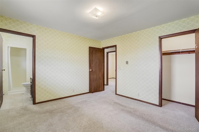 65 Yeoman Ln, Divide, CO 80814 - unfurnished bedroom with light colored carpet, a closet, baseboards, and connected bathroom