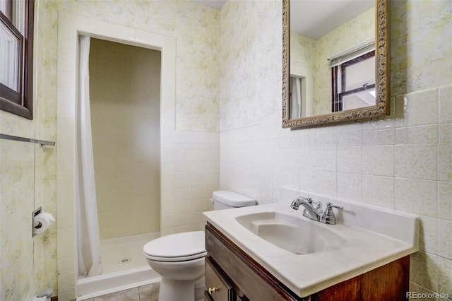 65 Yeoman Ln, Divide, CO 80814 - bathroom featuring wallpapered walls, toilet, tile walls, vanity, and a shower stall