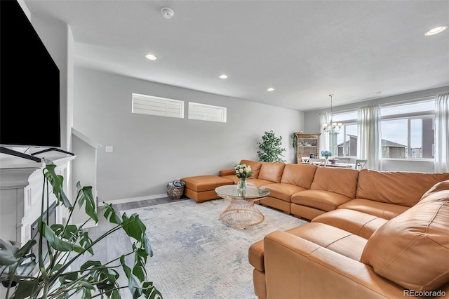 living room with recessed lighting, baseboards, and an inviting chandelier