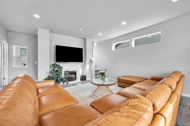 living room with recessed lighting, a fireplace, baseboards, and wood finished floors