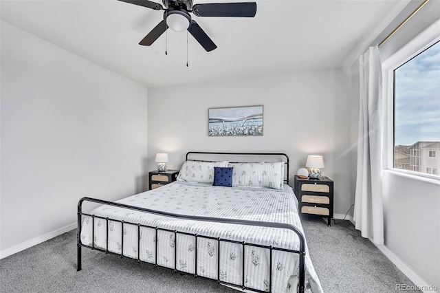 carpeted bedroom featuring baseboards and a ceiling fan