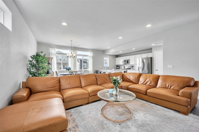 living room featuring recessed lighting and a chandelier