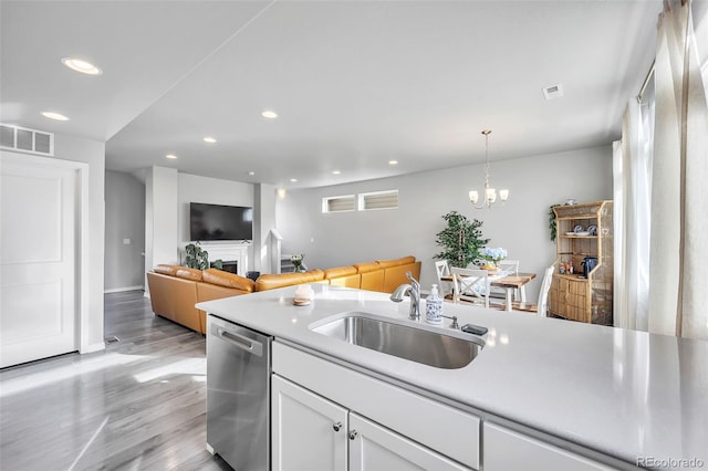 kitchen with visible vents, recessed lighting, stainless steel dishwasher, white cabinetry, and a sink