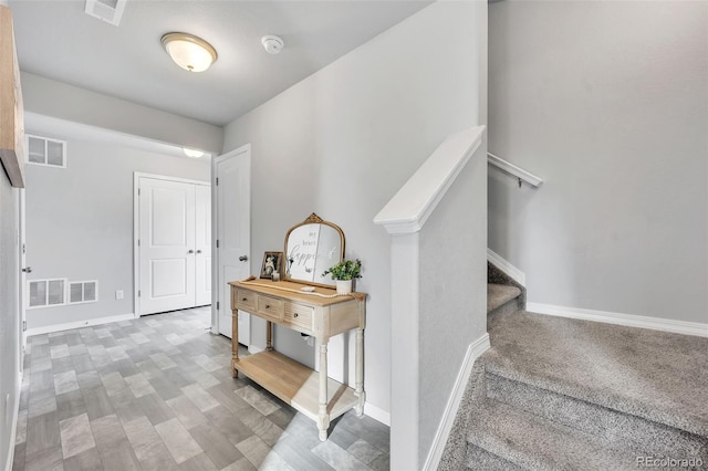 stairway with visible vents and baseboards