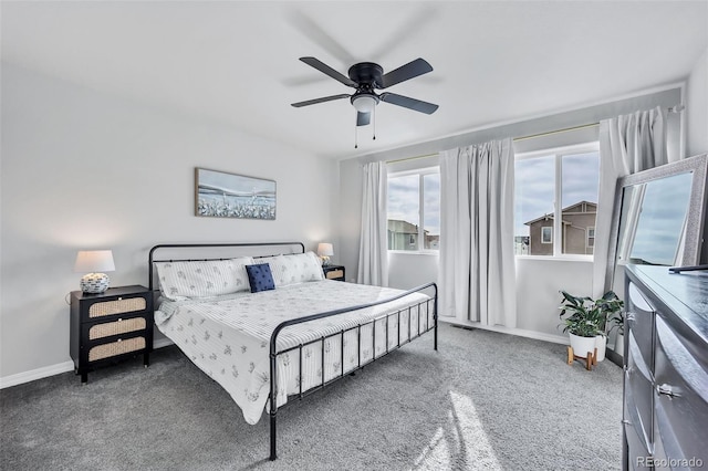 bedroom with a ceiling fan, baseboards, and carpet floors