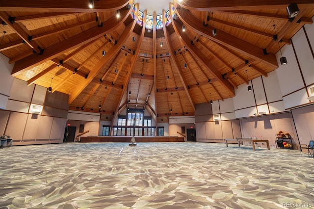 unfurnished bedroom with beamed ceiling, wood ceiling, and high vaulted ceiling