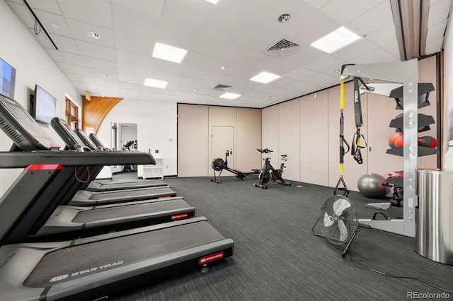 exercise room with visible vents and a paneled ceiling