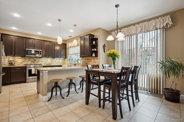 dining area featuring a chandelier, recessed lighting, and light tile patterned flooring