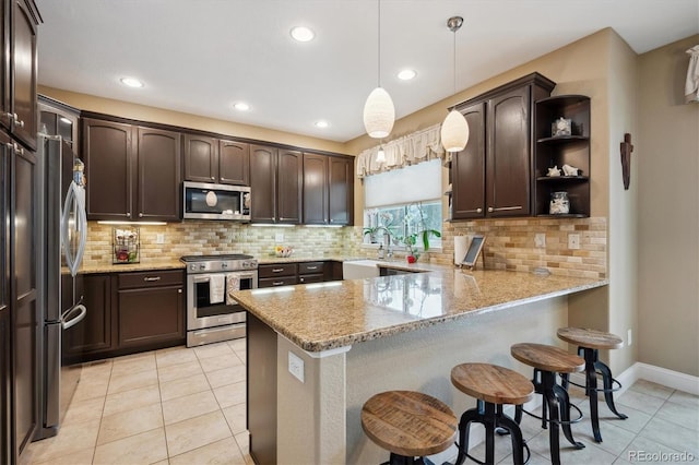 kitchen featuring dark brown cabinetry, light tile patterned floors, a peninsula, stainless steel appliances, and open shelves