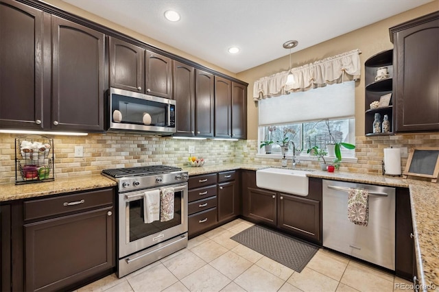 kitchen featuring dark brown cabinets, appliances with stainless steel finishes, a sink, and decorative backsplash