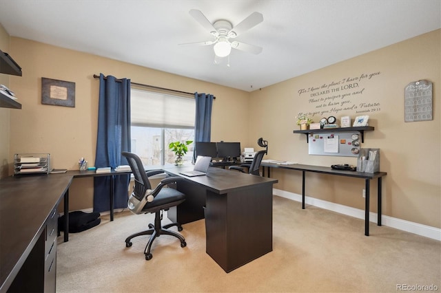 office space with light carpet, ceiling fan, and baseboards