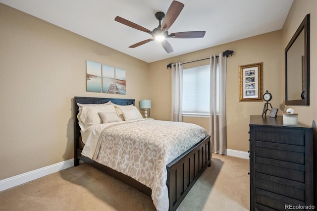 bedroom with light carpet, a ceiling fan, and baseboards