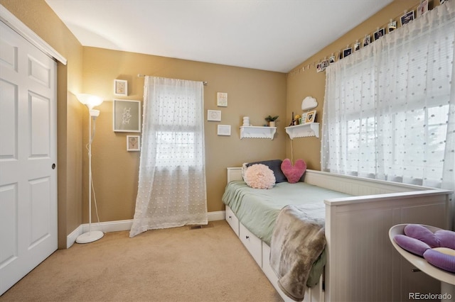 carpeted bedroom with baseboards