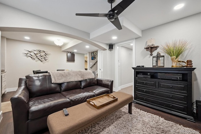 living area with arched walkways, recessed lighting, wood finished floors, a ceiling fan, and baseboards