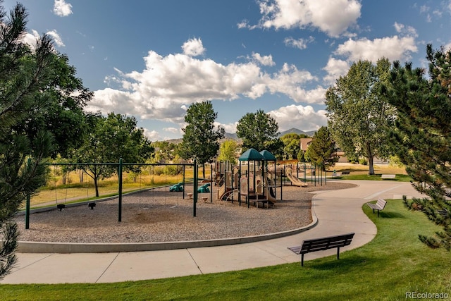 communal playground featuring a lawn