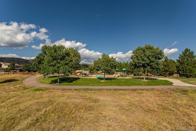 surrounding community featuring playground community and a yard