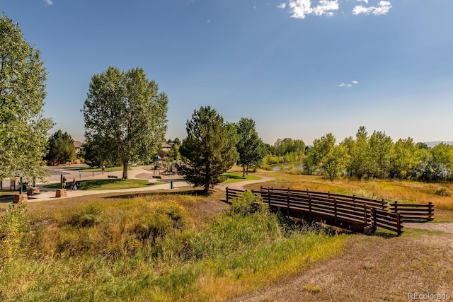 view of home's community featuring fence