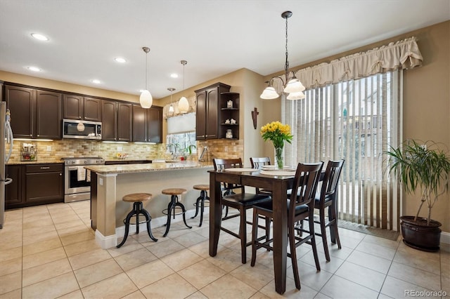 9882 S Hoyt Ct, Littleton, CO 80127 - dining room with a chandelier, light tile patterned floors, and recessed lighting
