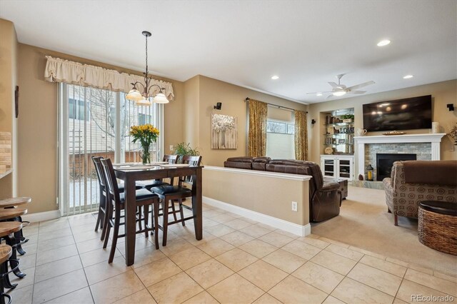 9882 S Hoyt Ct, Littleton, CO 80127 - dining room featuring a chandelier, light tile patterned floors, a fireplace, recessed lighting, and baseboards