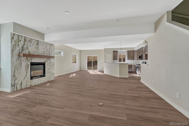 unfurnished living room with wood-type flooring and a fireplace