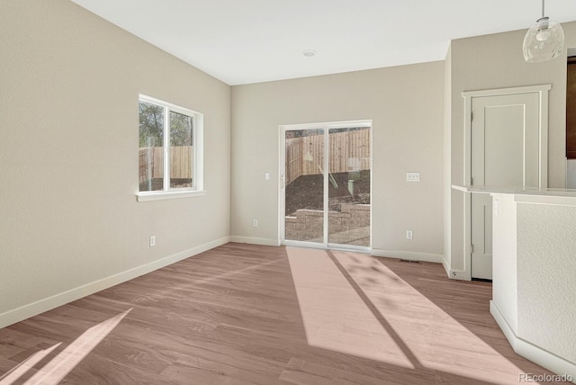 spare room featuring light hardwood / wood-style flooring