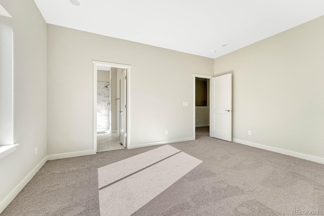 unfurnished bedroom featuring light colored carpet