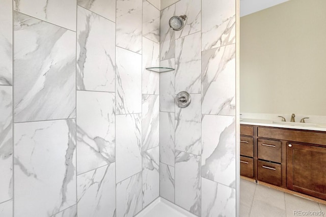 bathroom featuring vanity, tile patterned floors, and tiled shower