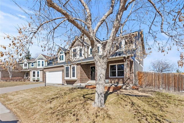 view of front of house featuring brick siding, fence, driveway, a residential view, and a front lawn