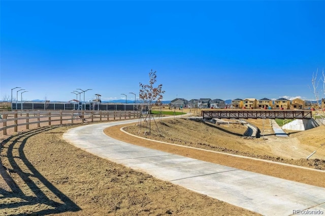 view of community with fence and a residential view