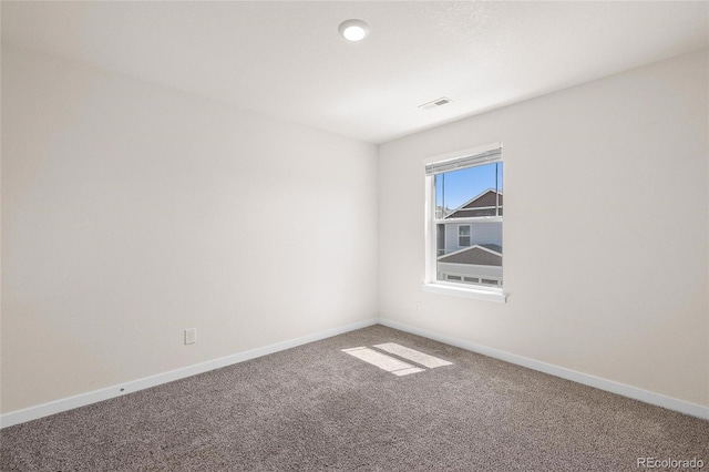 carpeted empty room with visible vents and baseboards