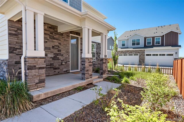 entrance to property with a garage and a porch