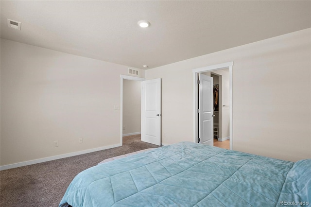 bedroom with carpet floors, baseboards, and visible vents