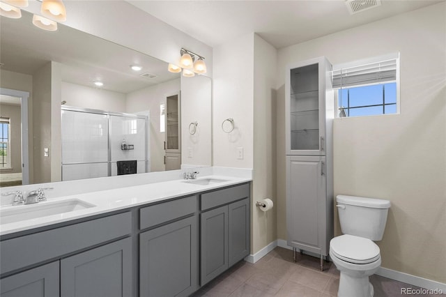 full bath featuring a healthy amount of sunlight, a shower stall, and a sink