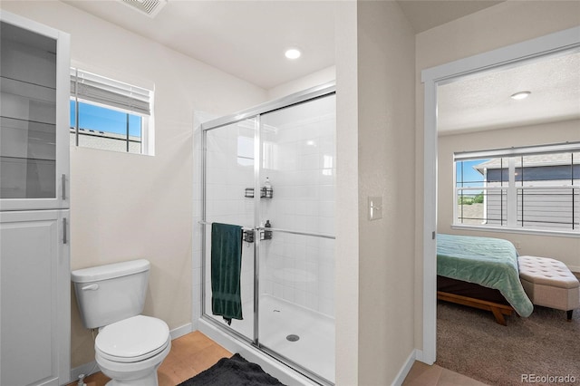 bathroom featuring ensuite bathroom, toilet, baseboards, a shower stall, and tile patterned floors