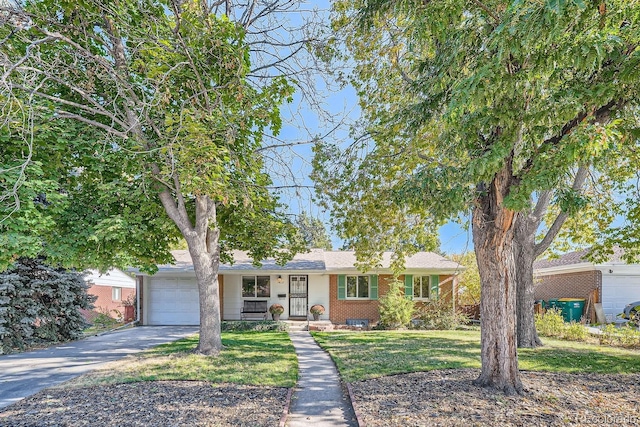 ranch-style home with a garage and a front yard