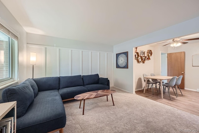 living room with wood-type flooring and ceiling fan