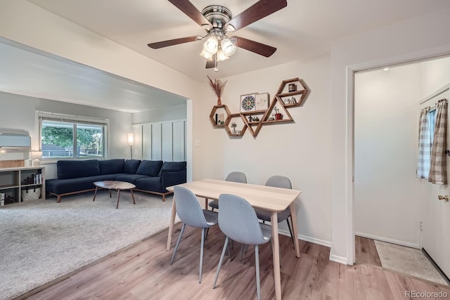 dining space featuring ceiling fan and light wood-type flooring