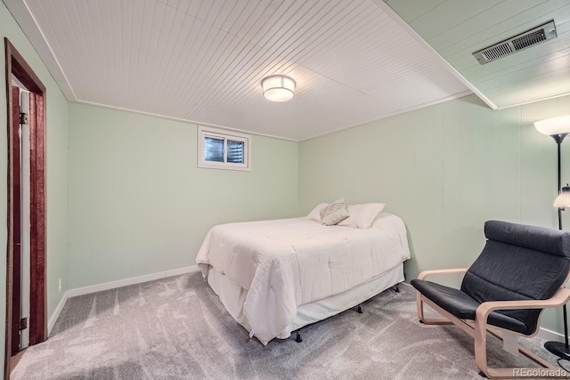 carpeted bedroom with wood ceiling