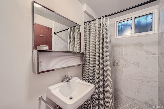 bathroom featuring walk in shower and sink