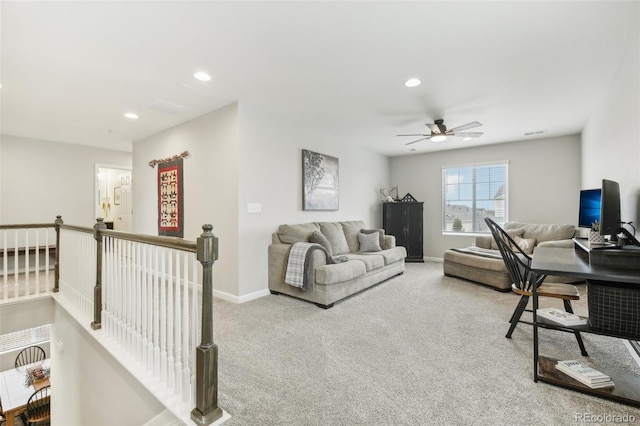 carpeted office space featuring ceiling fan