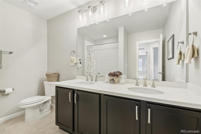 bathroom featuring tile patterned flooring, vanity, walk in shower, and toilet