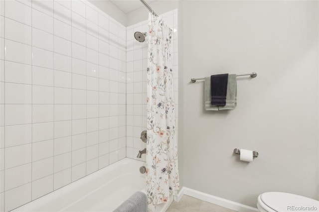 bathroom featuring shower / tub combo and toilet