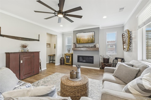 living room featuring crown molding, ceiling fan, and light hardwood / wood-style floors