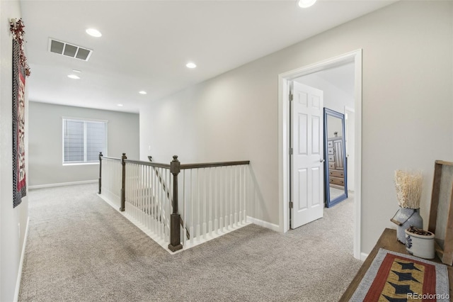 hallway featuring light carpet