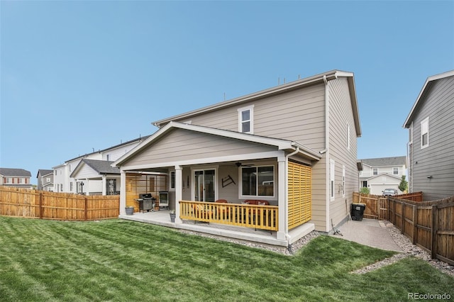 back of property featuring a ceiling fan, a patio, a fenced backyard, a residential view, and a yard