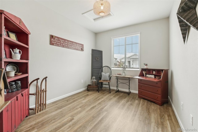 living area with light wood-type flooring and baseboards